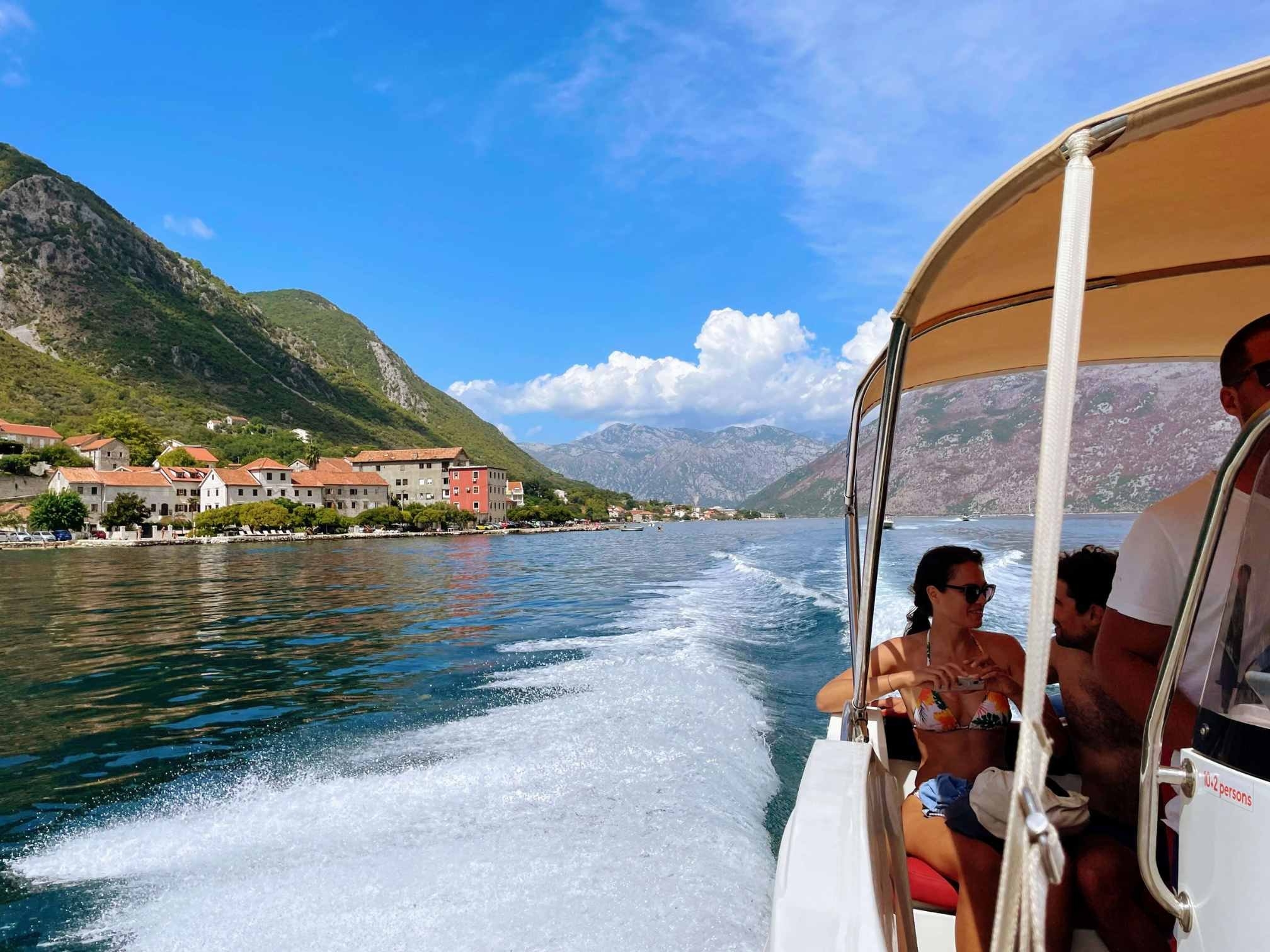 Boat ride around Kotor Bay surrounded by mountainous landscapes and blue summer skies