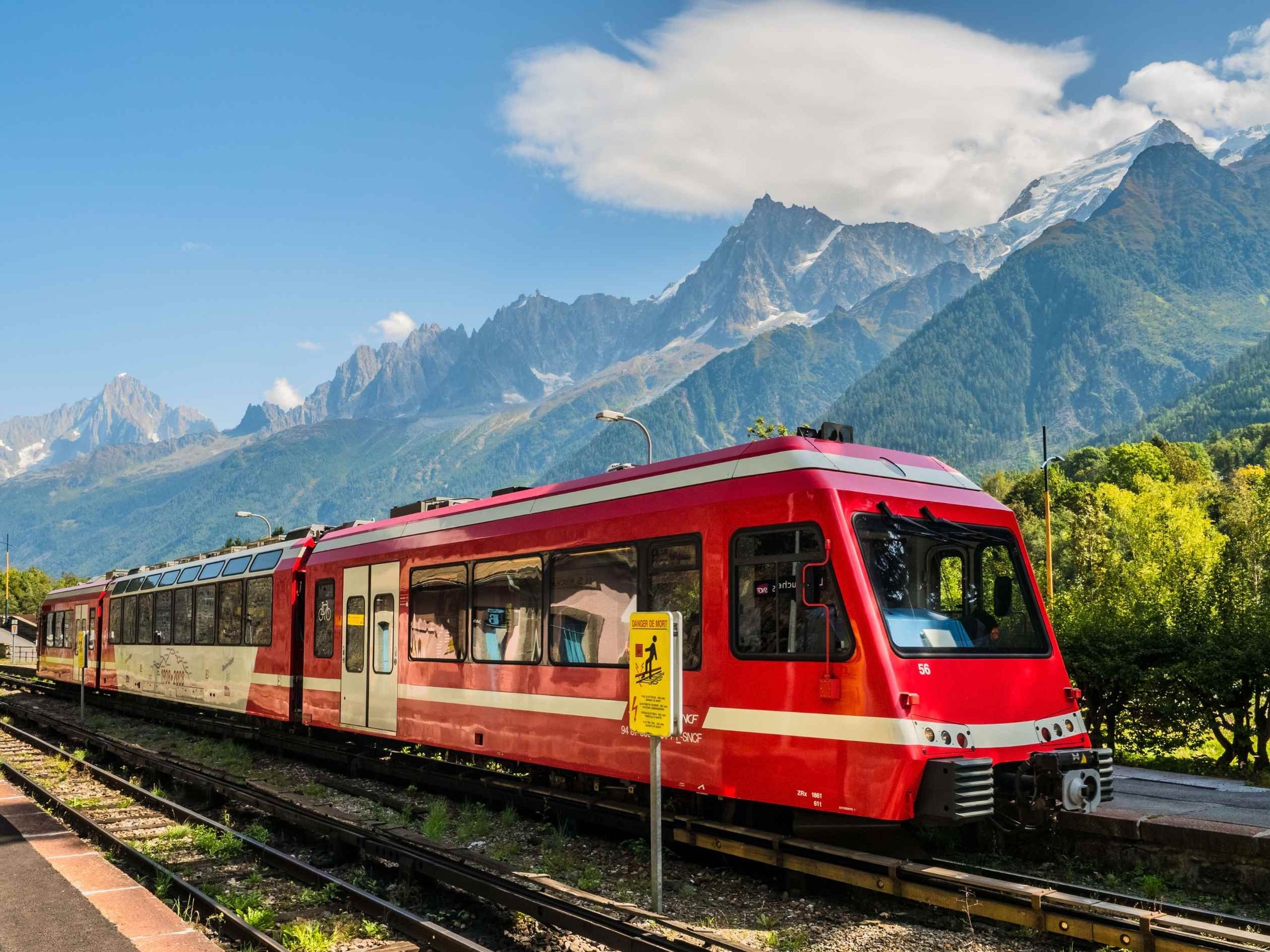 Red Chamonix-Mont-Blanc train service at chamonix station with beautiful mountain view.