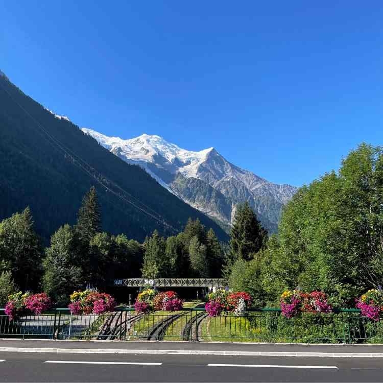 Chamonix train tracks with beautiful view of Mont Blanc snow-capped mountains and blue skies