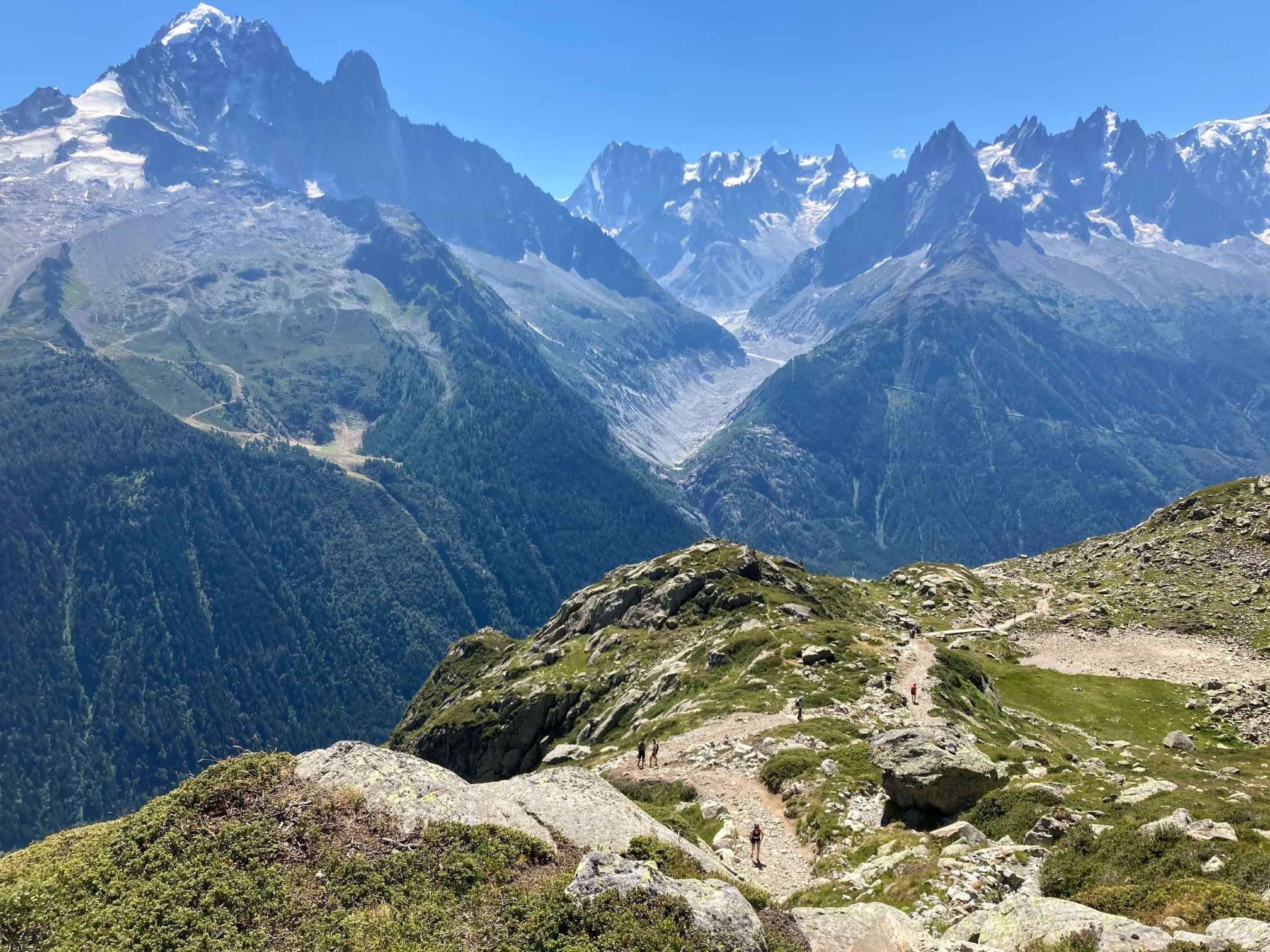 Panoramic view of snow-capped Mont Blanc Mountains and blue sky on easy Lac Blanc hike route..