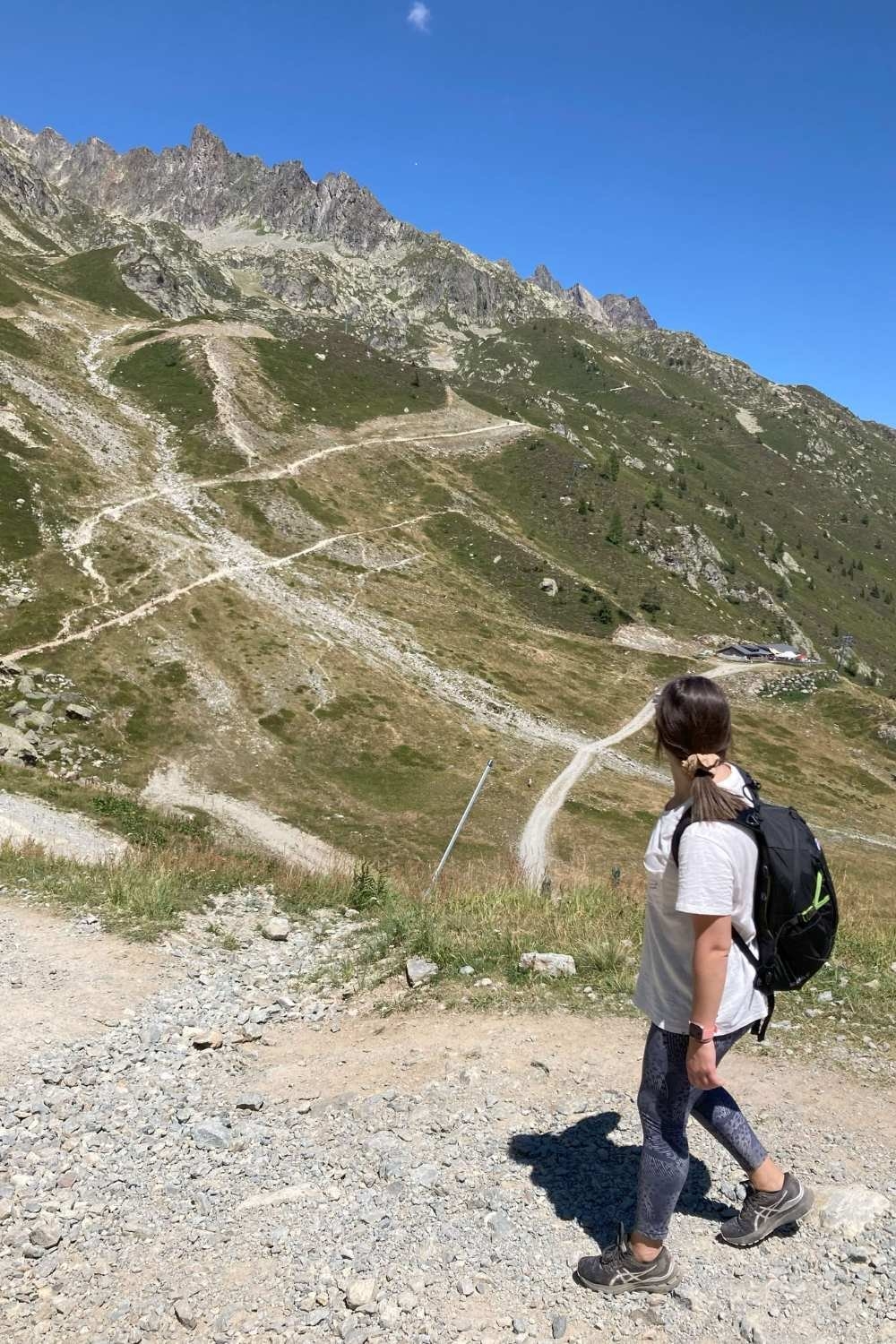 Female hiker looking at the steep La Flégère to Lac Blanc hike trail.